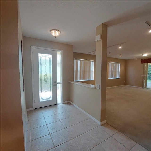 entrance foyer featuring light colored carpet