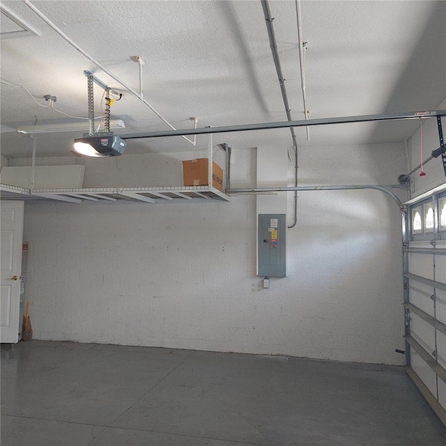 garage with a garage door opener and electric panel