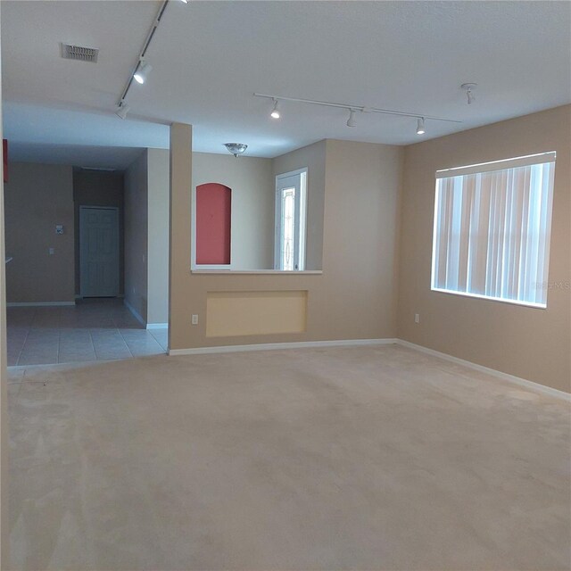 8049 Sanguinelli Rd, Land O Lakes, FL 34637 - empty room featuring track lighting, light carpet, and baseboards
