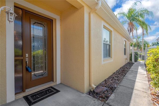 8049 Sanguinelli Rd, Land O Lakes, FL 34637 - property entrance with stucco siding and cooling unit