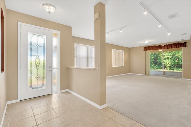 8049 Sanguinelli Rd, Land O Lakes, FL 34637 - entryway featuring baseboards, light tile patterned floors, and track lighting
