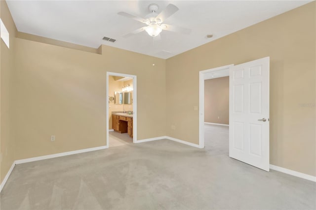 8049 Sanguinelli Rd, Land O Lakes, FL 34637 - unfurnished bedroom with baseboards, light carpet, ensuite bath, and ceiling fan