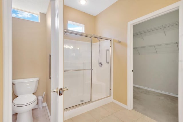 8049 Sanguinelli Rd, Land O Lakes, FL 34637 - full bathroom with a shower stall, toilet, a spacious closet, and baseboards