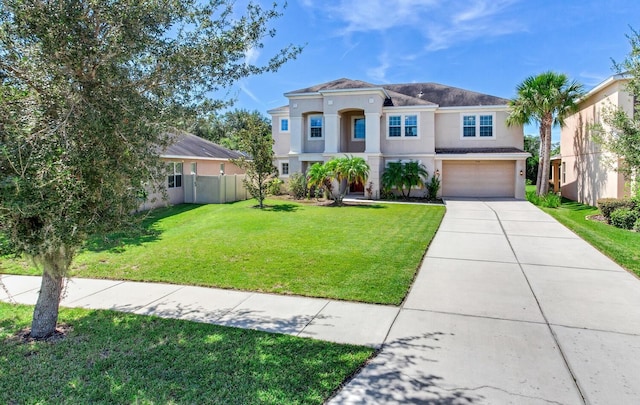 view of front of property featuring a front yard and a garage