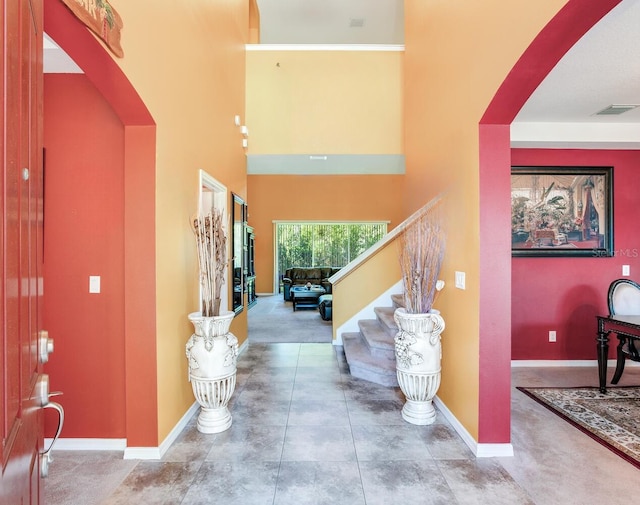 foyer entrance featuring a high ceiling and light tile flooring