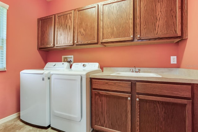 clothes washing area featuring hookup for a washing machine, cabinets, sink, and washer and dryer