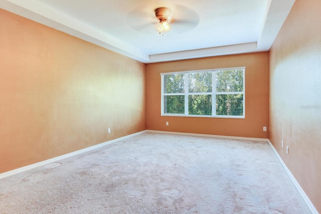 empty room featuring light carpet and ceiling fan