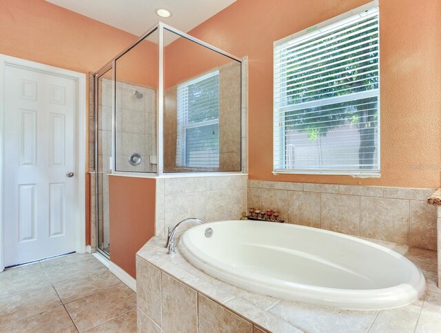 bathroom with tile flooring and plus walk in shower