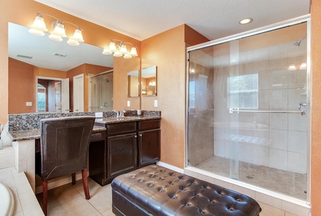 bathroom with an enclosed shower, tile floors, large vanity, double sink, and a textured ceiling