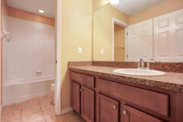 full bathroom with tiled shower / bath combo, vanity, tile floors, and toilet