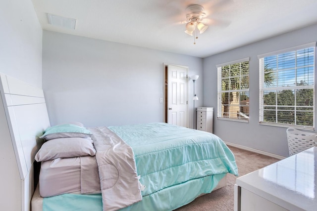 bedroom featuring light colored carpet and ceiling fan