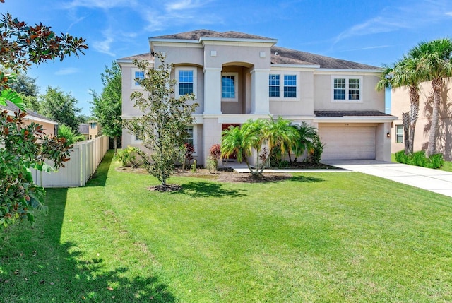 mediterranean / spanish home with a garage and a front lawn