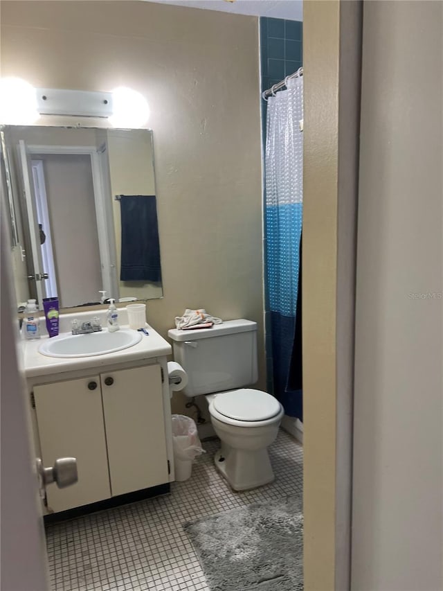 bathroom featuring oversized vanity, toilet, and tile flooring