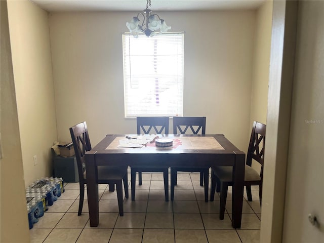 tiled dining space featuring a chandelier