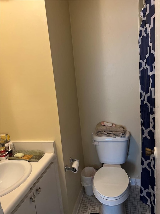 bathroom featuring vanity, tile floors, and toilet