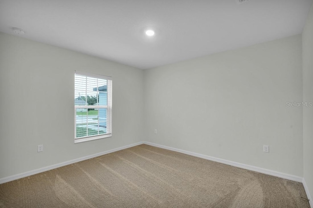 empty room featuring light carpet