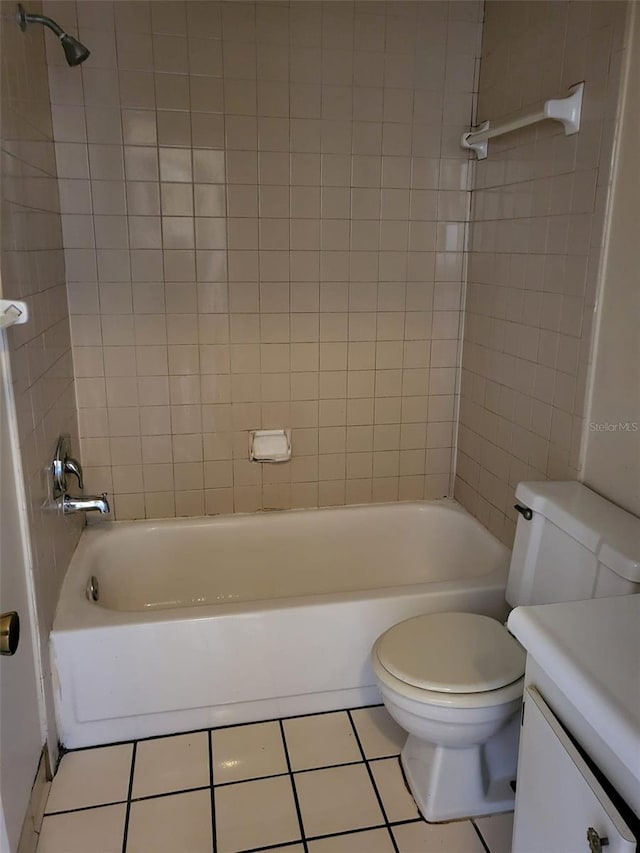 full bathroom featuring vanity, tiled shower / bath, toilet, and tile patterned flooring