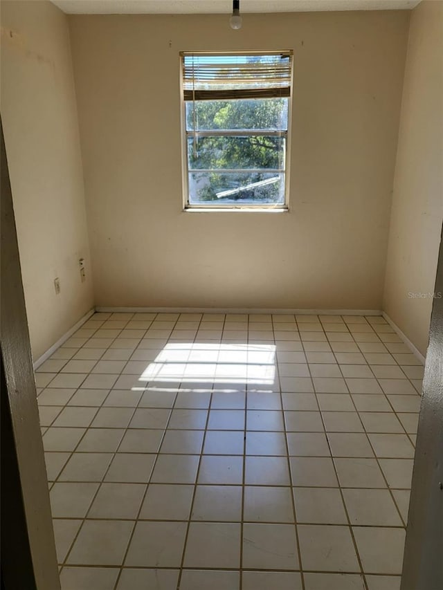 spare room featuring light tile patterned floors