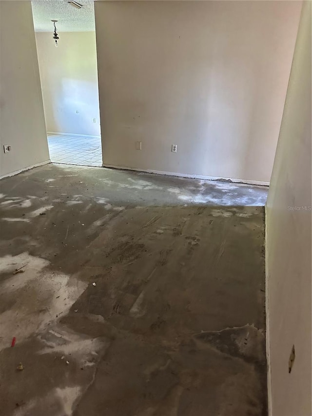 spare room with a textured ceiling