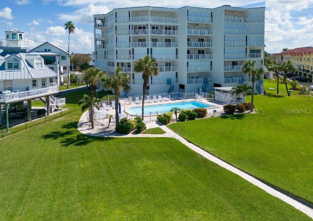 surrounding community featuring a pool and a lawn