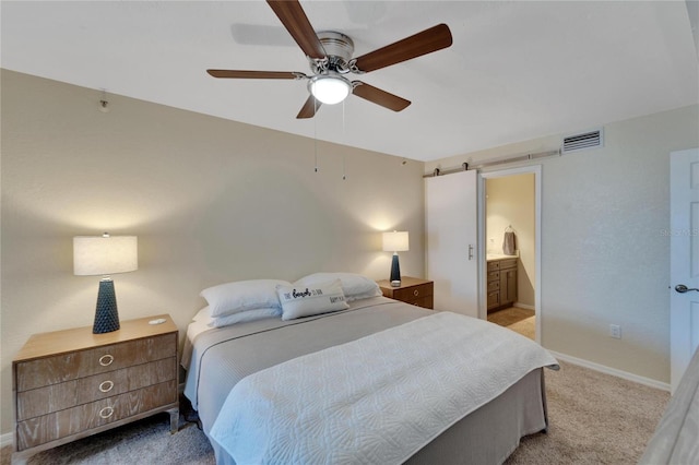 carpeted bedroom featuring connected bathroom and ceiling fan