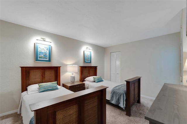 bedroom with light colored carpet and a closet