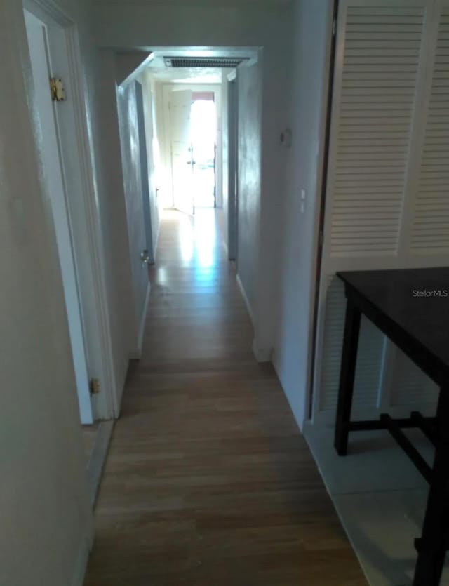 corridor with light hardwood / wood-style flooring