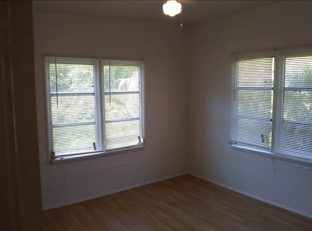 spare room featuring ceiling fan and dark wood-type flooring