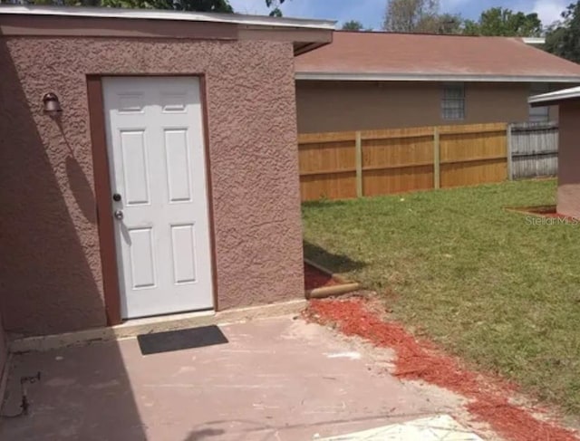 entrance to property with a lawn