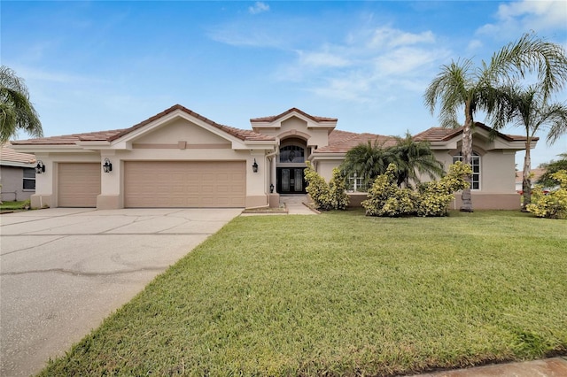 mediterranean / spanish home with a garage and a front yard