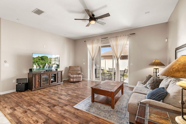 living room featuring ceiling fan and wood-type flooring