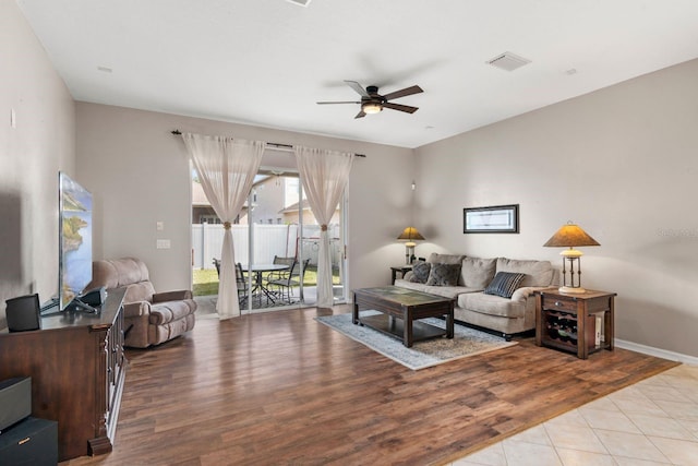 living room featuring light hardwood / wood-style flooring and ceiling fan