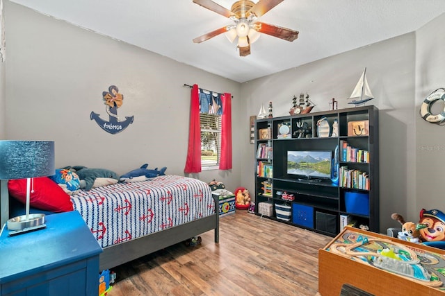 bedroom featuring ceiling fan and hardwood / wood-style floors