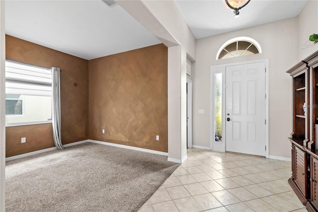 view of carpeted foyer entrance