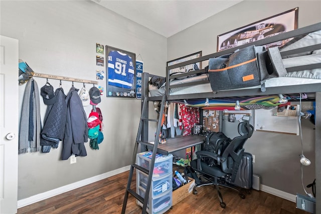 bedroom with dark hardwood / wood-style floors