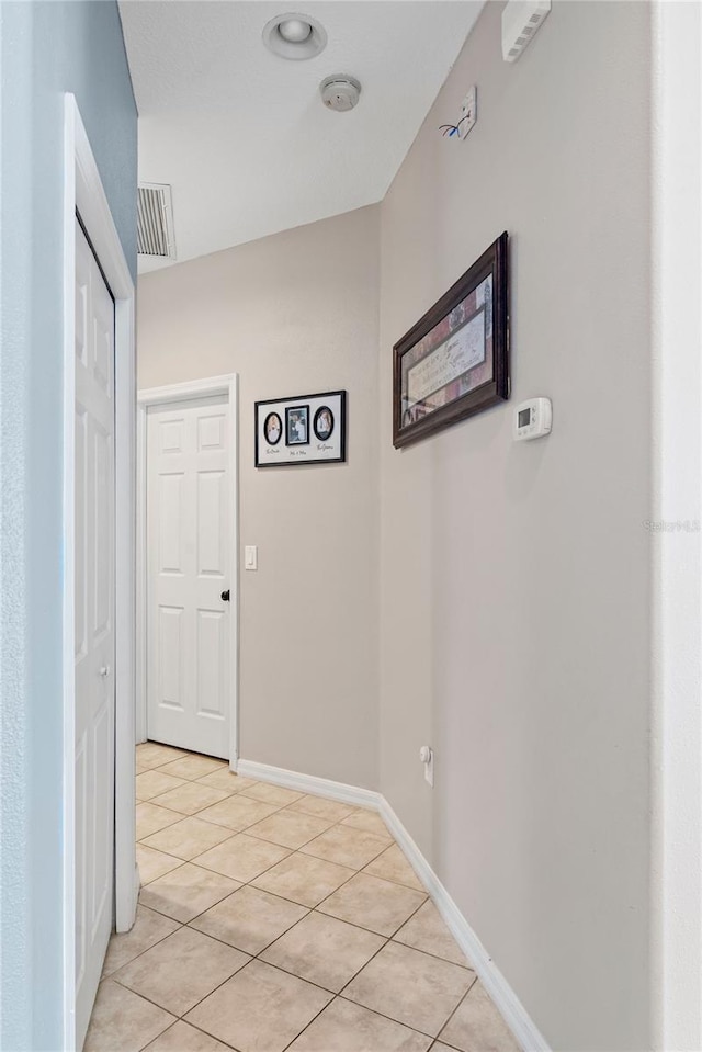 corridor featuring light tile patterned floors