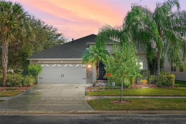 view of front of home featuring a yard and a garage