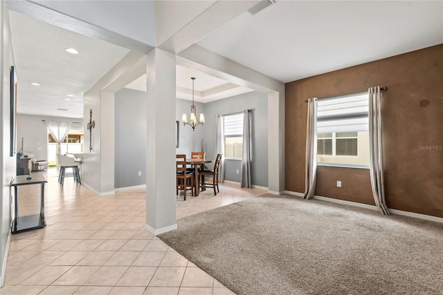 carpeted dining room with an inviting chandelier