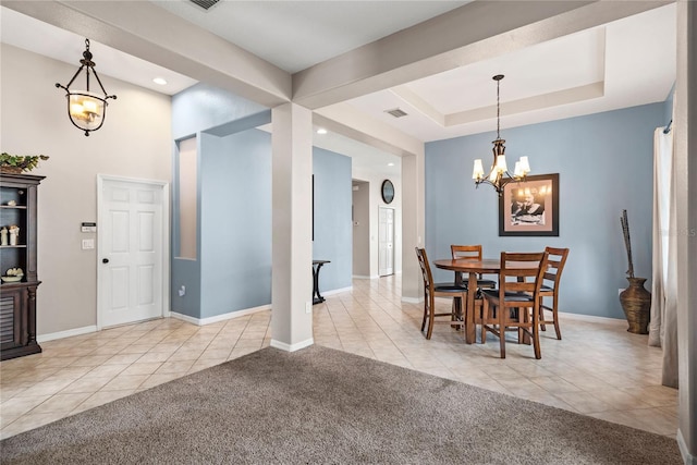 dining area featuring light colored carpet, a tray ceiling, and an inviting chandelier