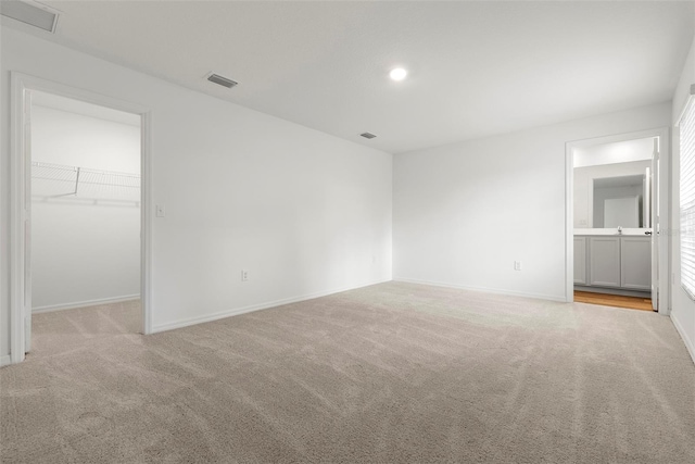 unfurnished room with light colored carpet