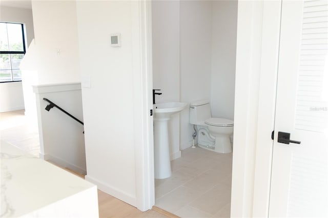 half bathroom featuring a sink and toilet