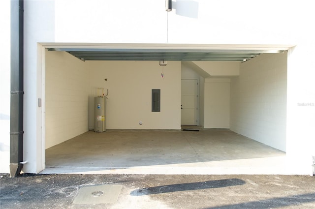 garage with electric panel, water heater, and concrete block wall