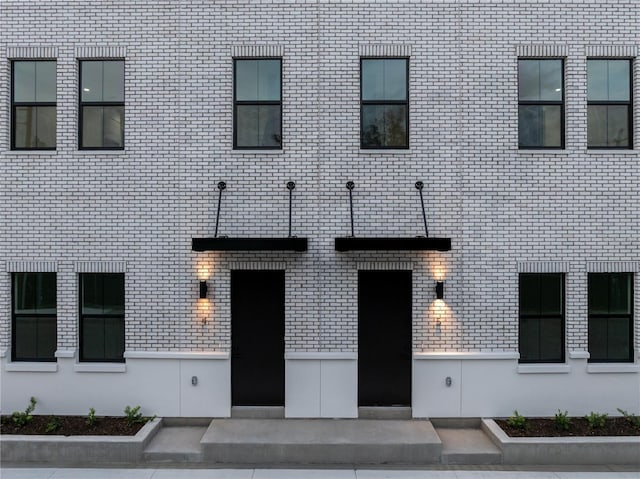 property entrance with brick siding