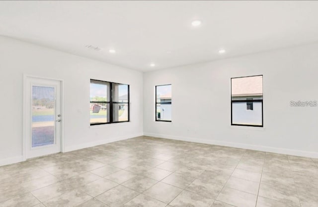7002 162nd Pl E, Parrish, FL 34219 - empty room with light tile patterned floors, baseboards, visible vents, and recessed lighting