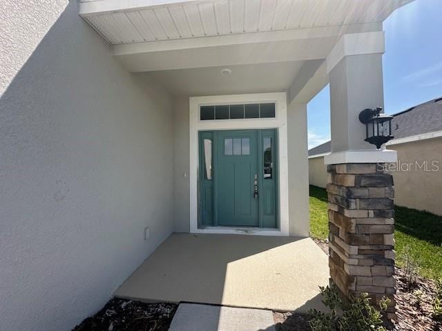7002 162nd Pl E, Parrish, FL 34219 - property entrance with visible vents and stucco siding