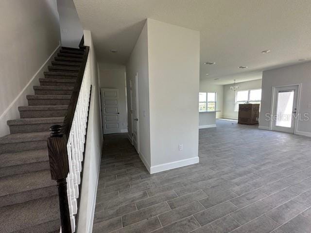 7002 162nd Pl E, Parrish, FL 34219 - stairs with baseboards, wood tiled floor, and recessed lighting