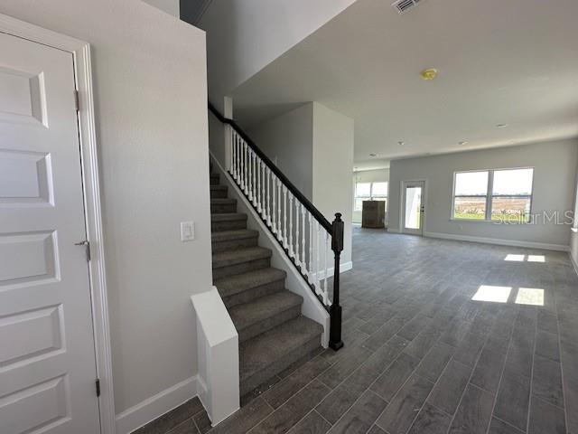 7002 162nd Pl E, Parrish, FL 34219 - staircase featuring wood finished floors and baseboards