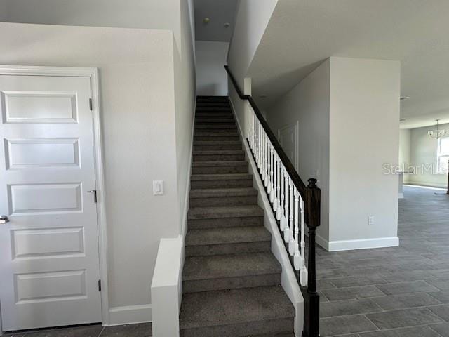 7002 162nd Pl E, Parrish, FL 34219 - staircase with baseboards and an inviting chandelier