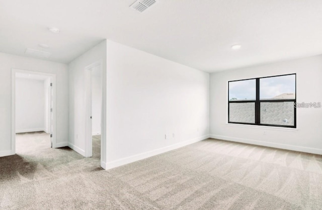 7002 162nd Pl E, Parrish, FL 34219 - spare room with visible vents, baseboards, and light carpet
