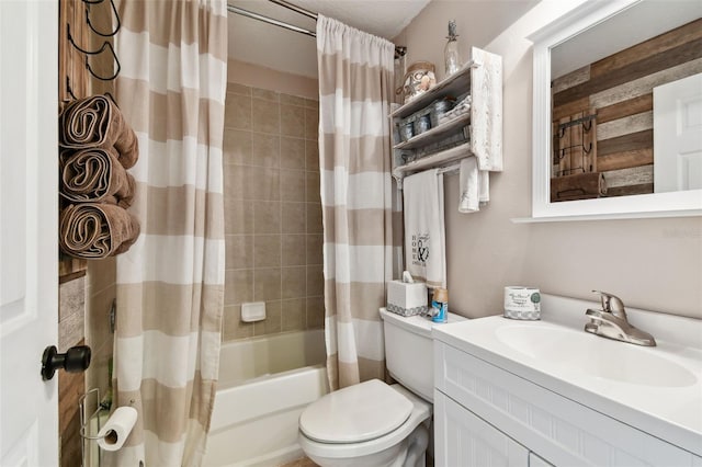 full bathroom with large vanity, shower / tub combo, and toilet